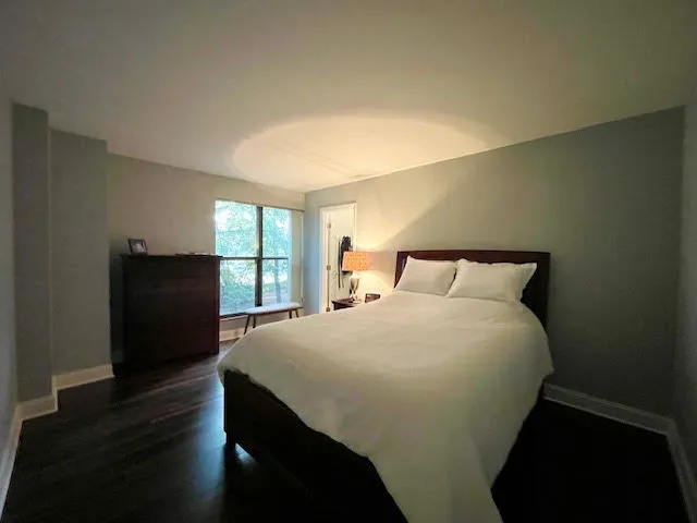 a bedroom with a bed and wooden floor