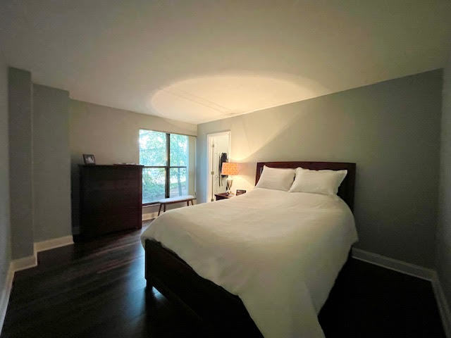 509 Aurora Avenue, Unit 308 Naperville, IL 60540 - Photo 9 of 22 a bedroom with a bed and wooden floor