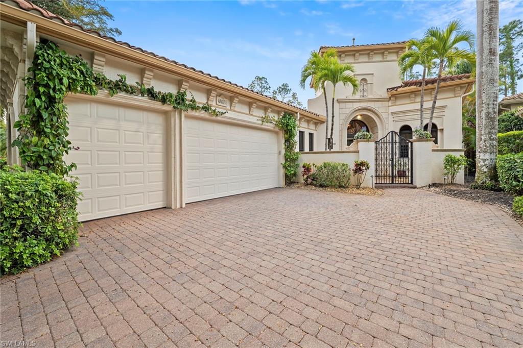 18071 Lagos Way Naples, FL 34110 - Photo 11 of 44 a front view of a house with a yard and garage
