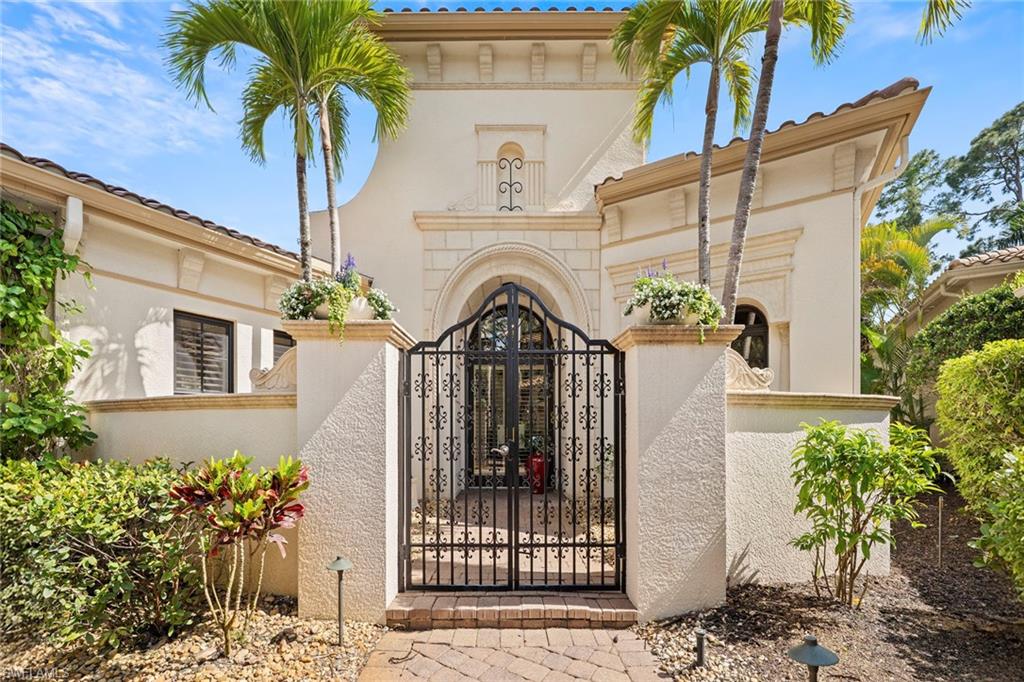 18071 Lagos Way Naples, FL 34110 - Photo 12 of 44 a front view of a house with a garden
