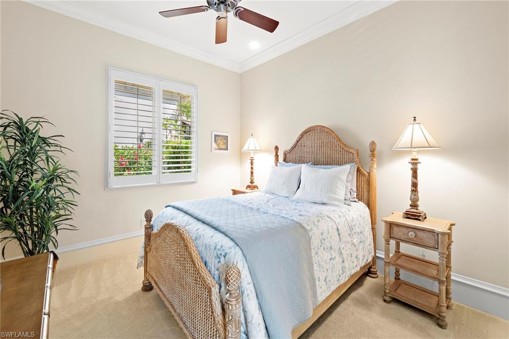 18071 Lagos Way Naples, FL 34110 - Photo 13 of 44 a bedroom with a bed and a chandelier