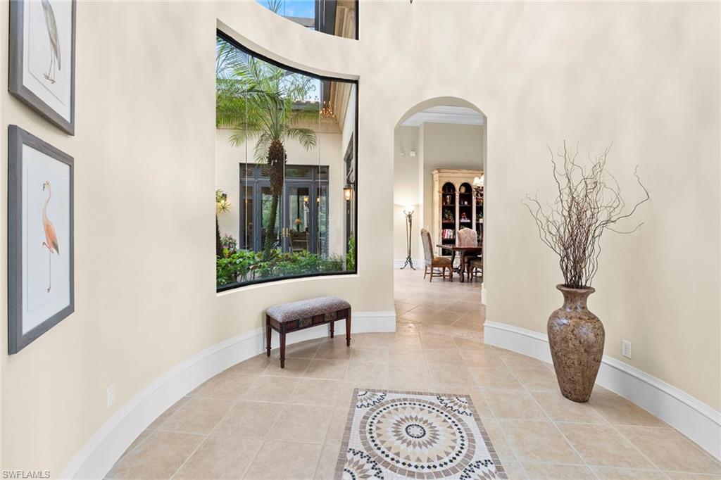 18071 Lagos Way Naples, FL 34110 - Photo 16 of 44 a view of a hallway with wooden floor and a potted plant
