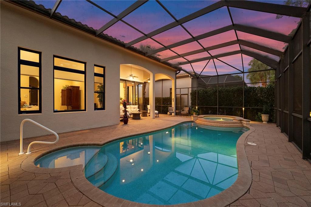 18071 Lagos Way Naples, FL 34110 - Photo 2 of 44 a view of swimming pool with seating space