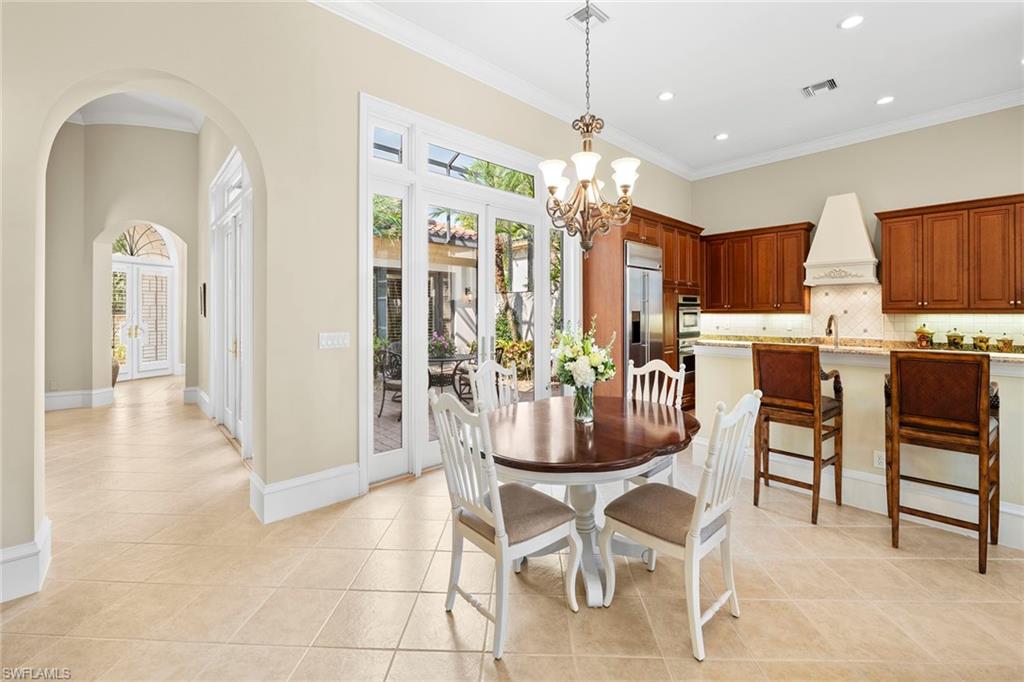 18071 Lagos Way Naples, FL 34110 - Photo 22 of 44 a view of a dining room with furniture