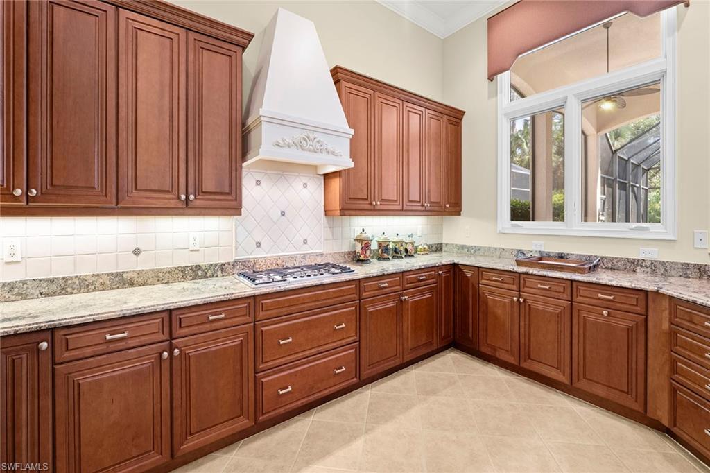 18071 Lagos Way Naples, FL 34110 - Photo 24 of 44 a kitchen with stainless steel appliances granite countertop cabinets and window