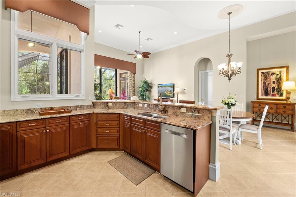 18071 Lagos Way Naples, FL 34110 - Photo 25 of 44 a kitchen with lots of counter top space and dining table