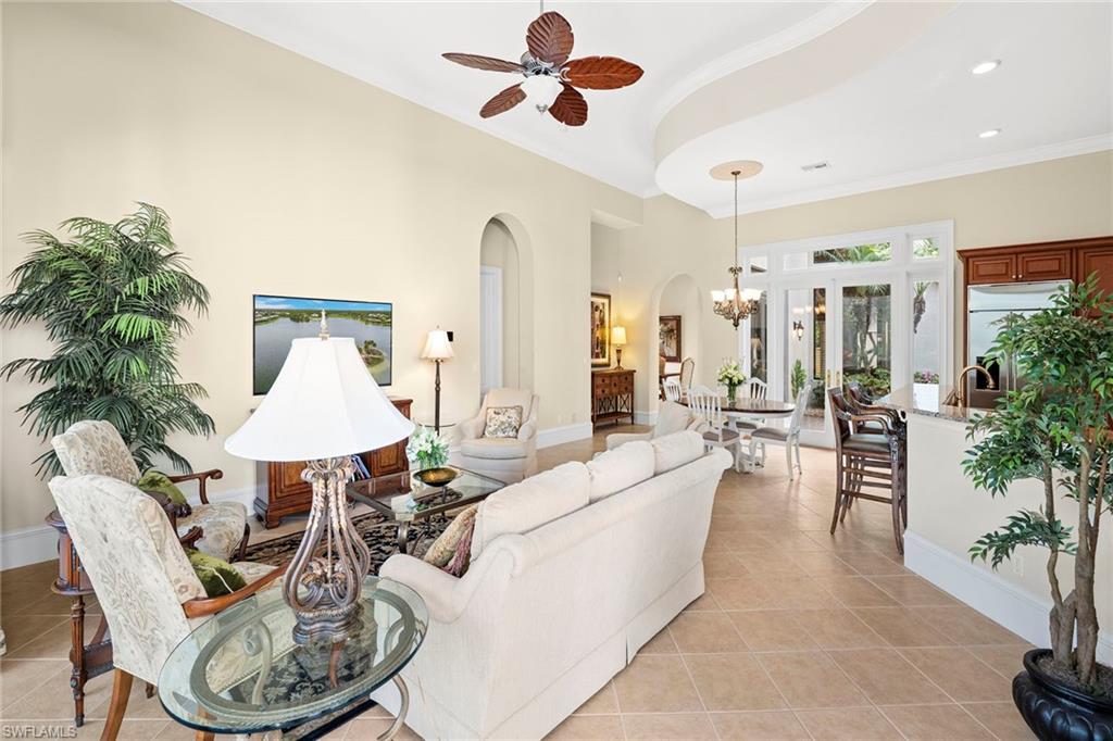 18071 Lagos Way Naples, FL 34110 - Photo 26 of 44 a living room with furniture kitchen view and a potted plant