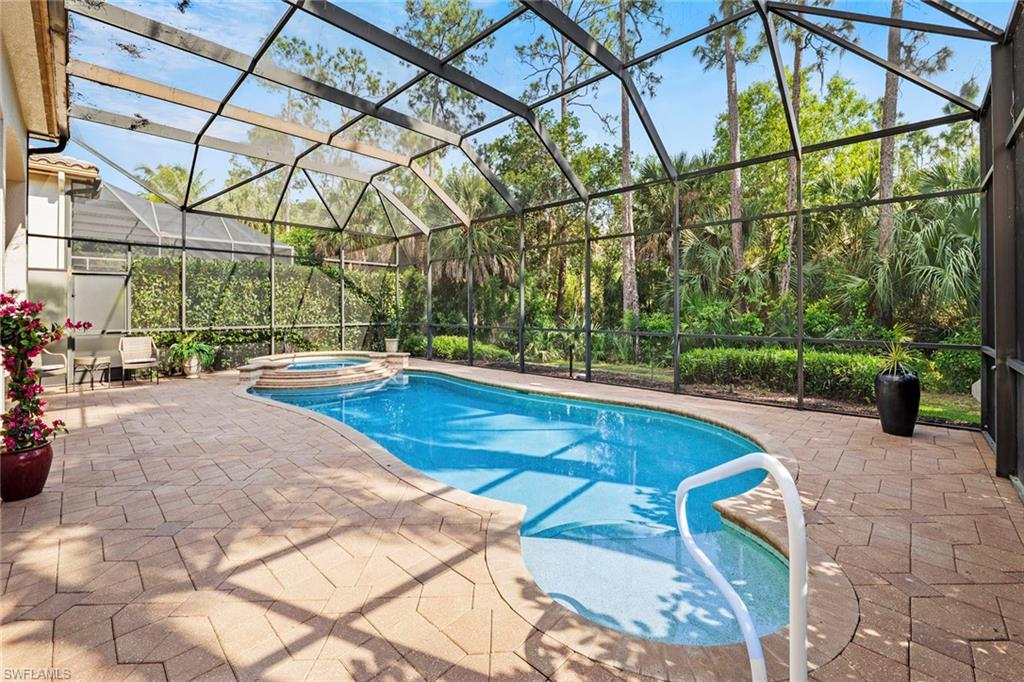18071 Lagos Way Naples, FL 34110 - Photo 28 of 44 a view of a swimming pool with a patio