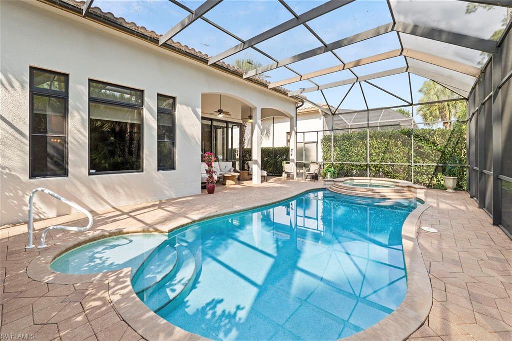 18071 Lagos Way Naples, FL 34110 - Photo 30 of 44 a view of a swimming pool with a patio