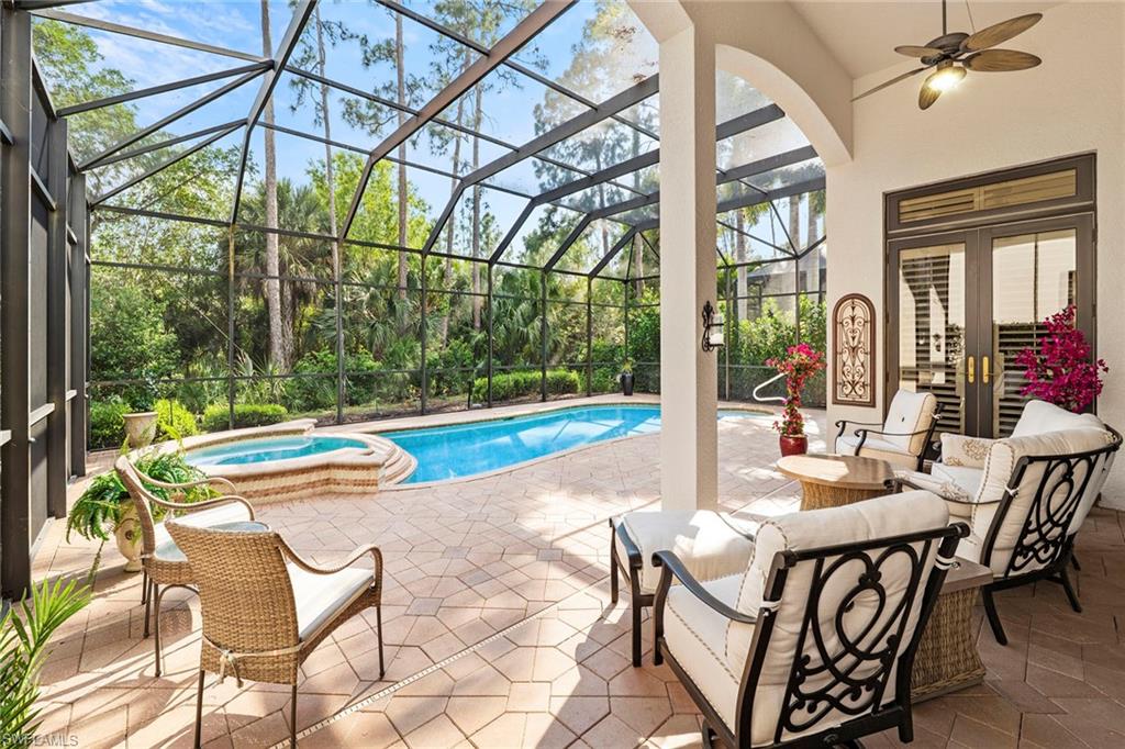 18071 Lagos Way Naples, FL 34110 - Photo 3 of 44 a view of an outdoor space with swimming pool and furniture