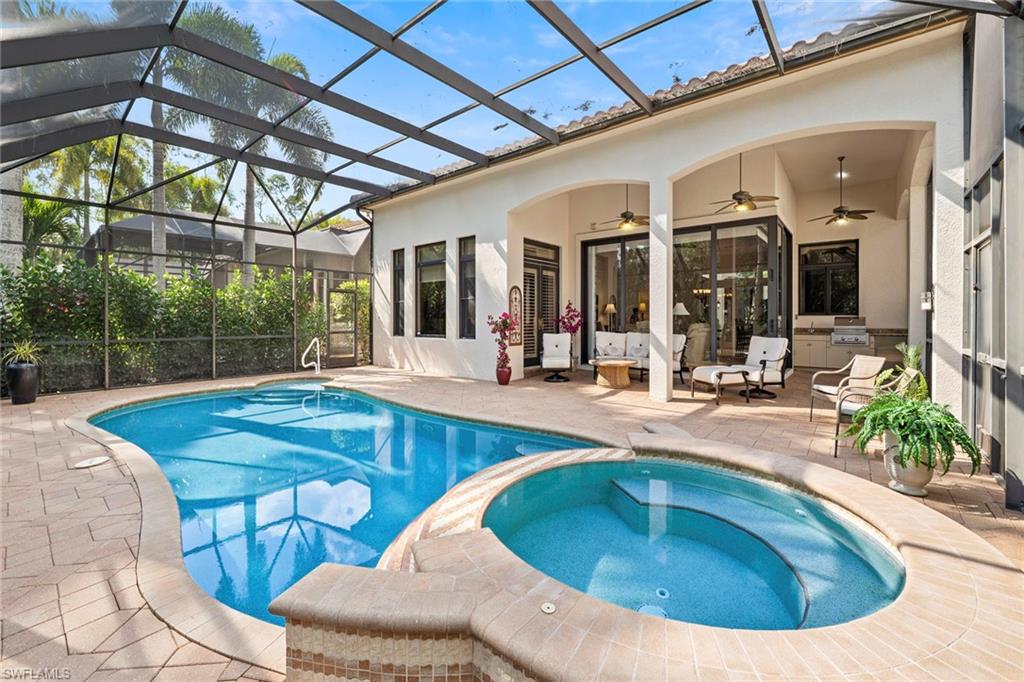 18071 Lagos Way Naples, FL 34110 - Photo 31 of 44 a view of a swimming pool with outdoor seating