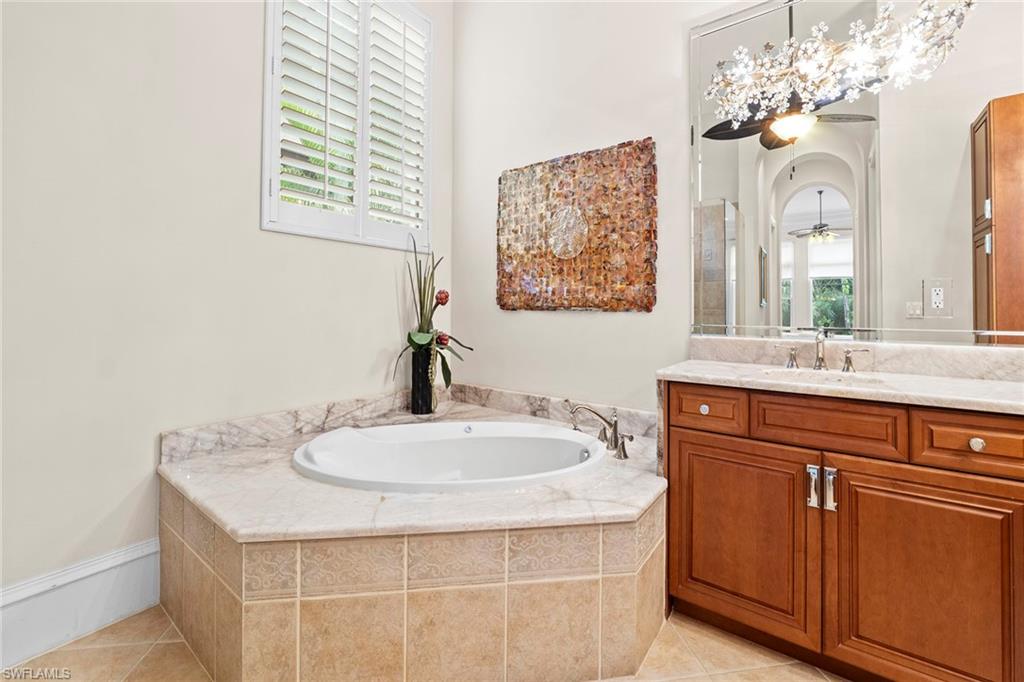 18071 Lagos Way Naples, FL 34110 - Photo 35 of 44 a bathroom with a sink vanity and a mirror
