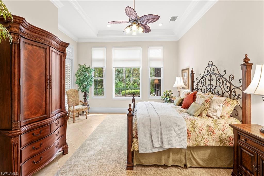 18071 Lagos Way Naples, FL 34110 - Photo 37 of 44 a bed room with a bed and a chandelier