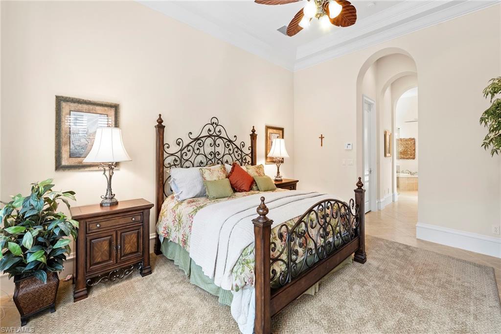 18071 Lagos Way Naples, FL 34110 - Photo 39 of 44 a bedroom with a bed and a chandelier