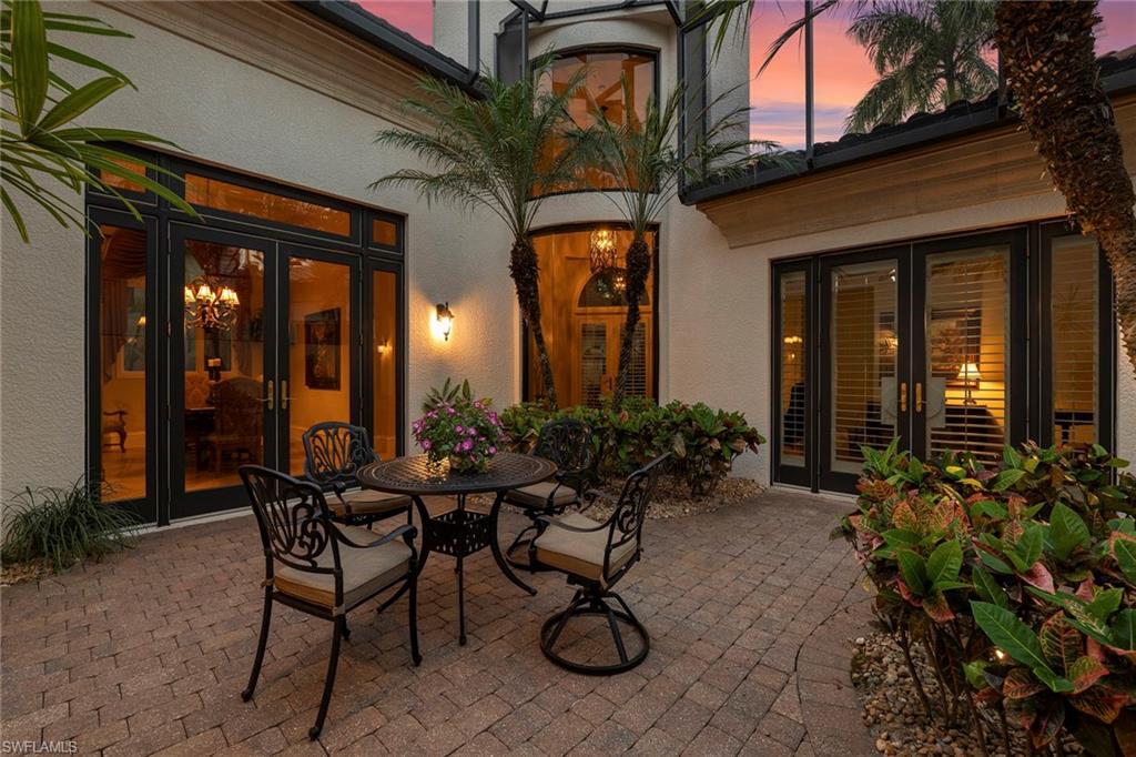 18071 Lagos Way Naples, FL 34110 - Photo 40 of 44 a view of a house with sitting area and garden