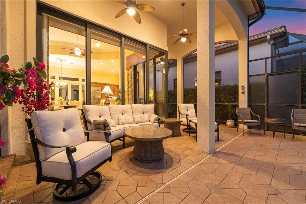 18071 Lagos Way Naples, FL 34110 - Photo 41 of 44 a living room with fireplace furniture and a large window