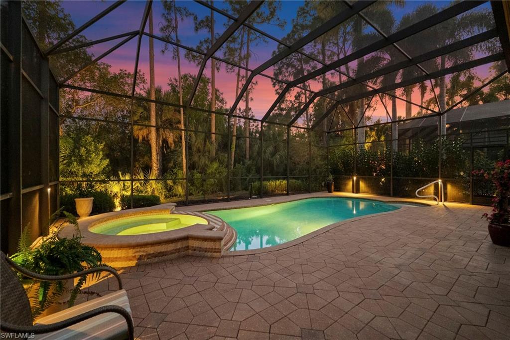18071 Lagos Way Naples, FL 34110 - Photo 43 of 44 a view of a swimming pool with a patio and a yard