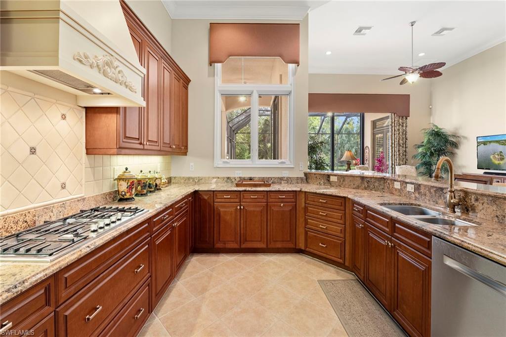 18071 Lagos Way Naples, FL 34110 - Photo 5 of 44 a large kitchen with stainless steel appliances granite countertop a stove and a sink