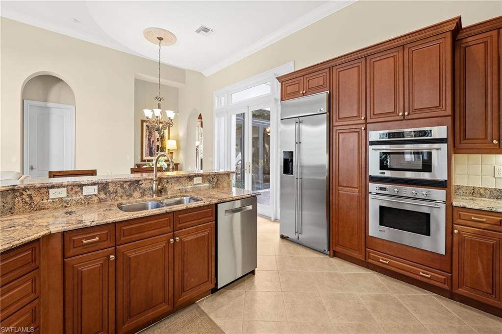18071 Lagos Way Naples, FL 34110 - Photo 6 of 44 a kitchen with stainless steel appliances granite countertop a refrigerator and a stove top oven