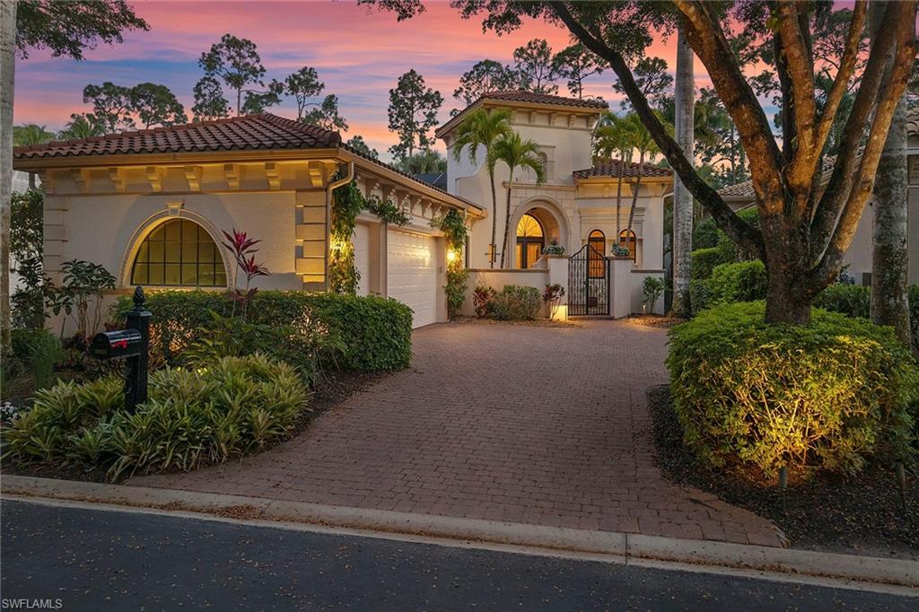 18071 Lagos Way Naples, FL 34110 - Photo 10 of 44 a front view of a house with garden