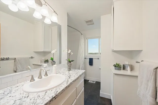 a large white kitchen with stainless steel appliances