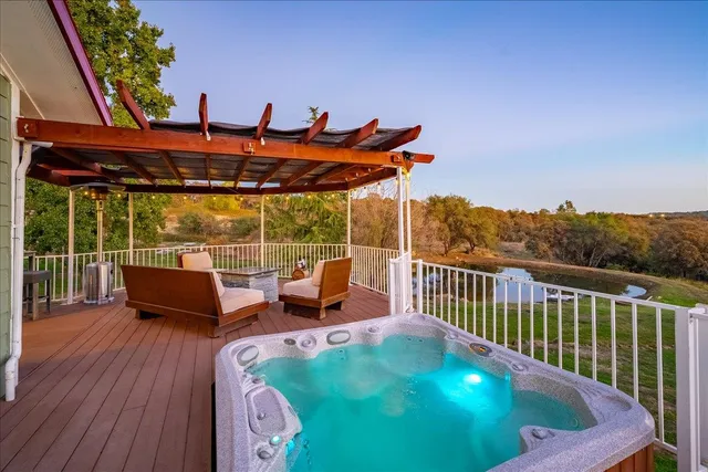 a view of a house with wooden deck and furniture