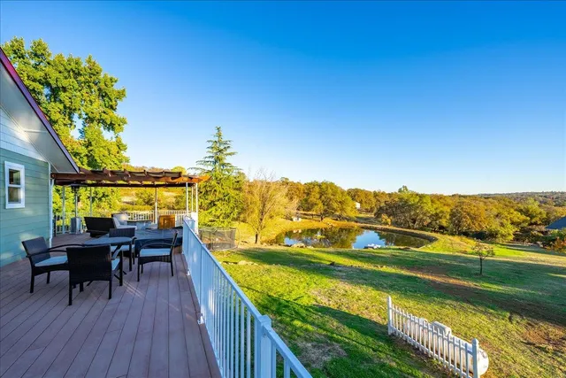 an aerial view of residential houses with outdoor space and river