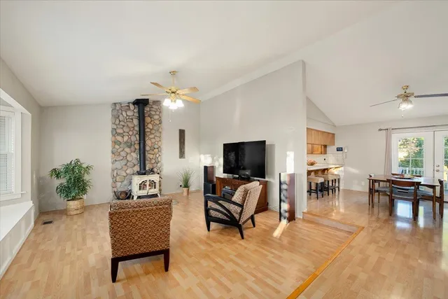 a view of a kitchen with wooden floor electronic appliances and a window