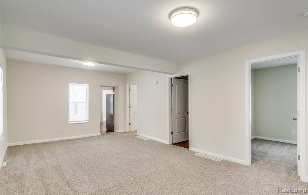 2365 Welch Road Walled Lake, MI 48390 - Photo 4 of 14 Spacious room featuring neutral carpet flooring, light-toned walls, and recessed lighting