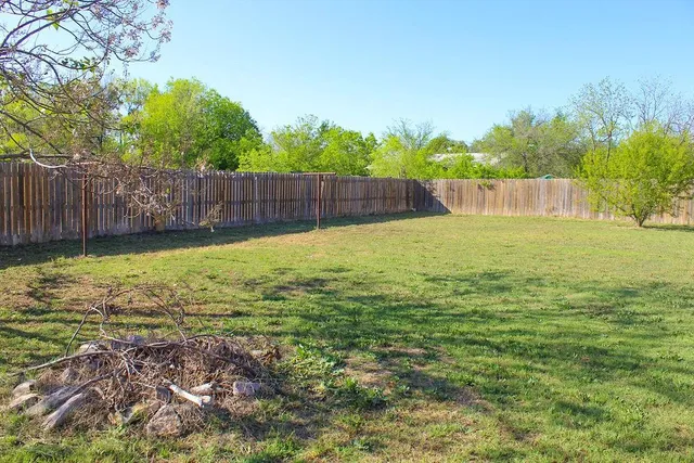 a view of a backyard with table and chairs