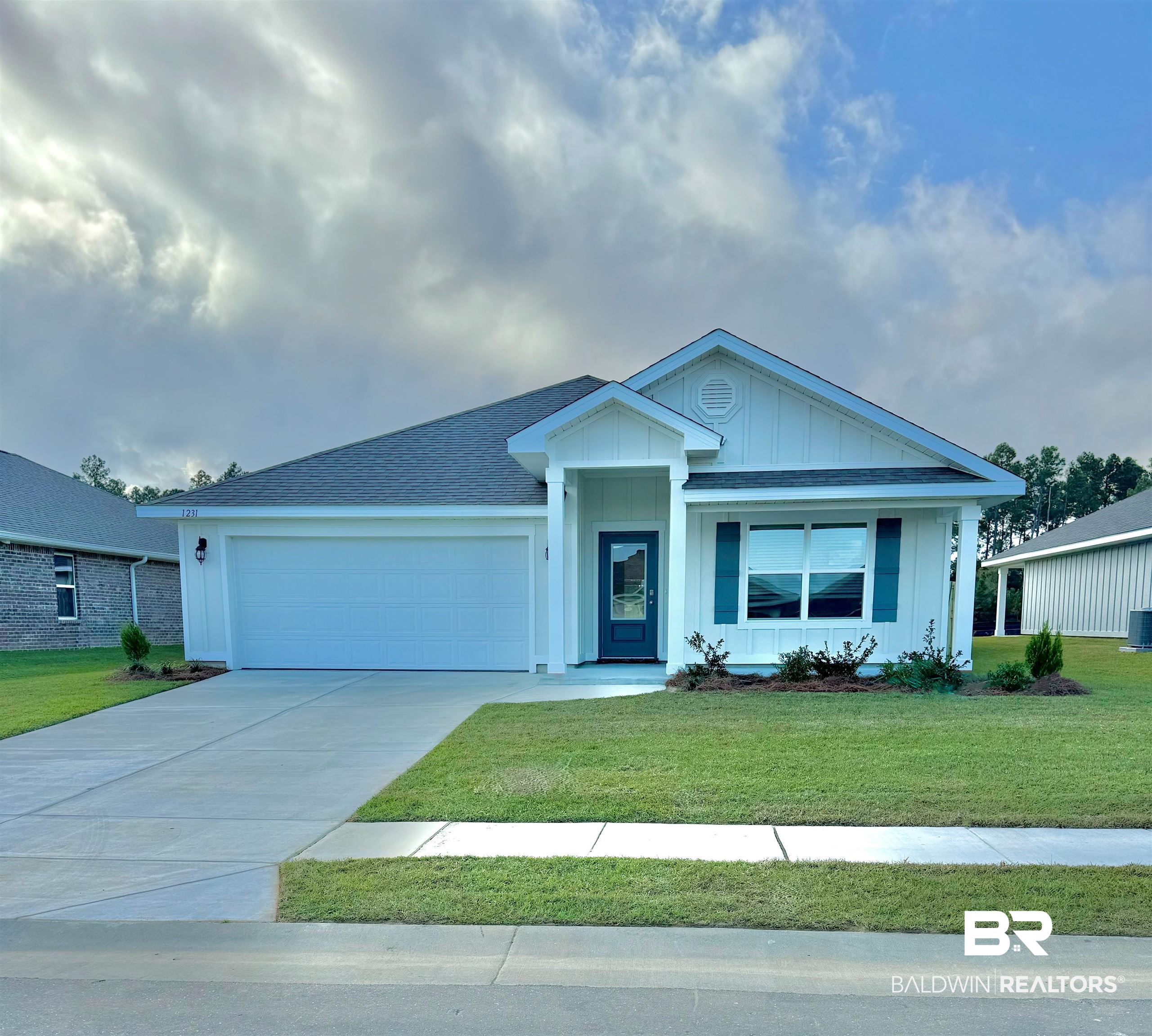 1231 Hayward Loop Foley, AL 36535 - Photo 1 of 24 View of front facade with a front yard and a garage