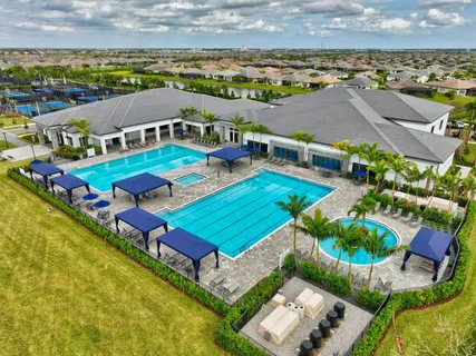 an aerial view of a house with swimming pool outdoor seating and yard