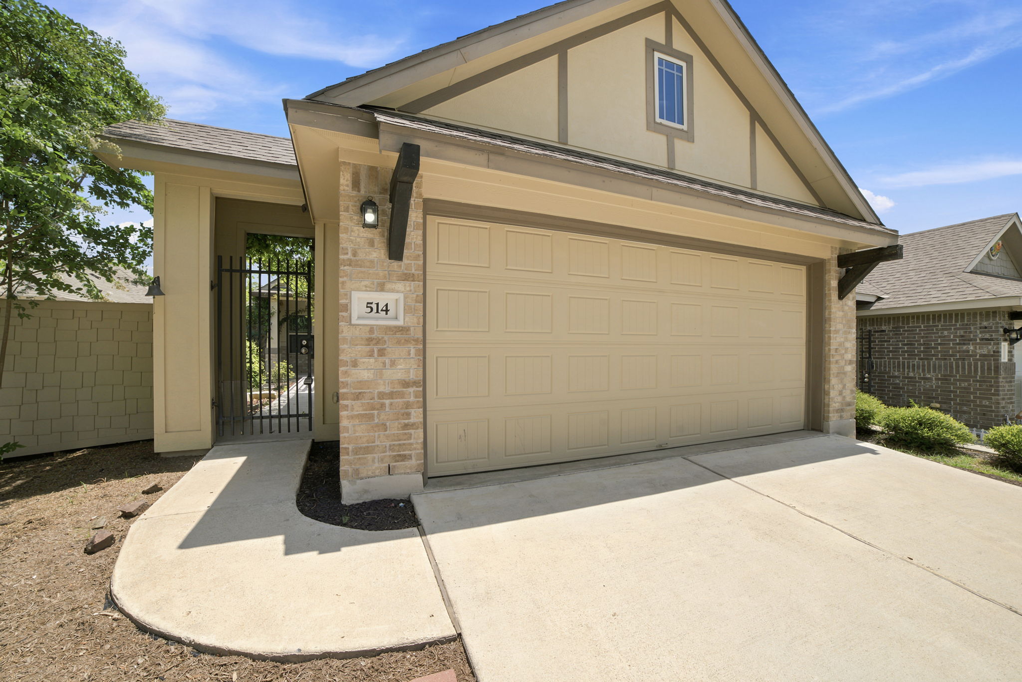 514 Nautical Loop Kyle, TX 78640 - Photo 2 of 24 A welcoming front exterior featuring a spacious garage and an ornate gated entry to the property.