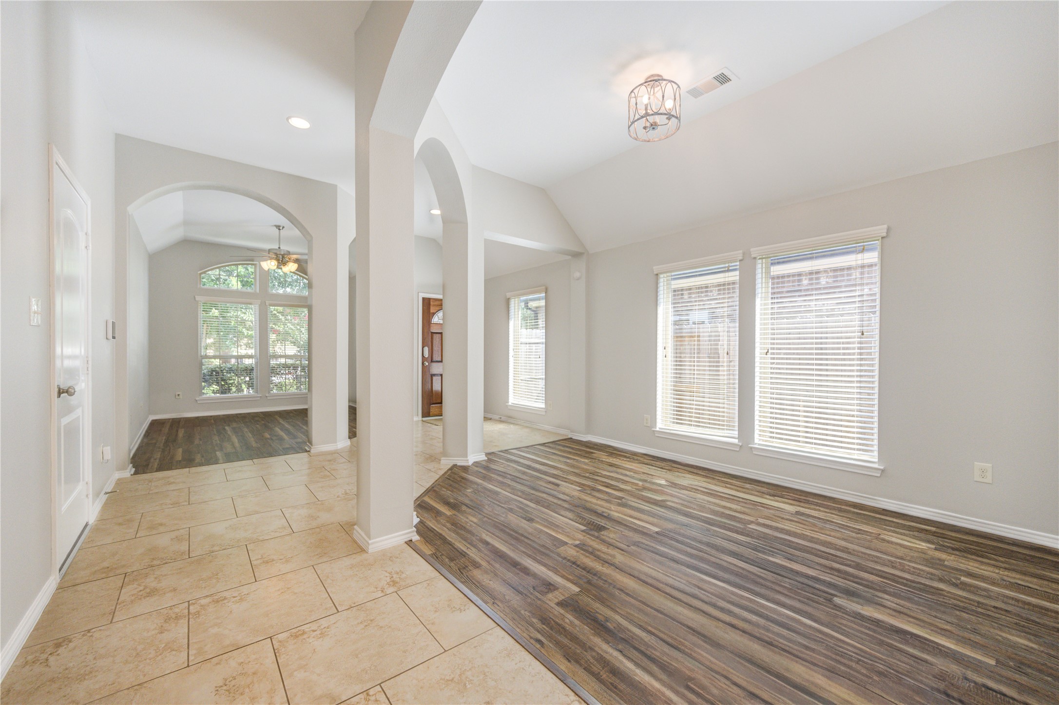 27407 Gatlin Lane Spring, TX 77386 - Photo 12 of 35 This final view highlights the exceptional flow and flexibility found at the front of the home. Framed by elegant archways and soaring ceilings, the open-concept design seamlessly connects the foyer, dining area, and dedicated office or flex space, creating an inviting layout that adapts beautifully to both everyday living and entertaining.