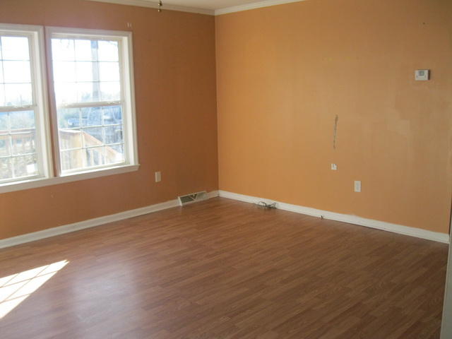 870 Kings Store Road Northeast Check, VA 24072 - Photo 14 of 18 an empty room with wooden floor and windows