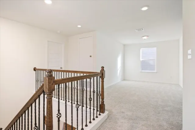 a kitchen with a sink dishwasher a stove and white cabinets with wooden floor