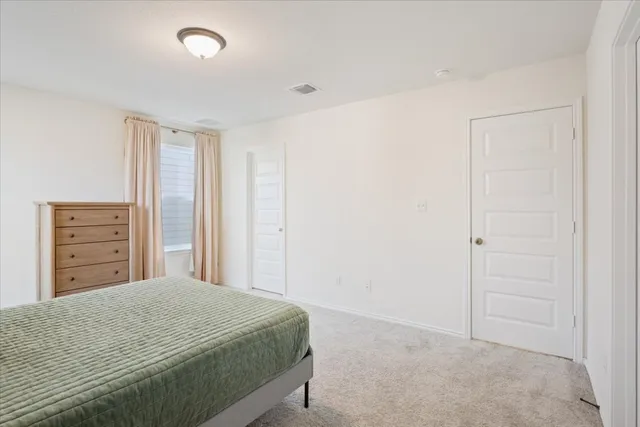 a bedroom with a bed and dresser