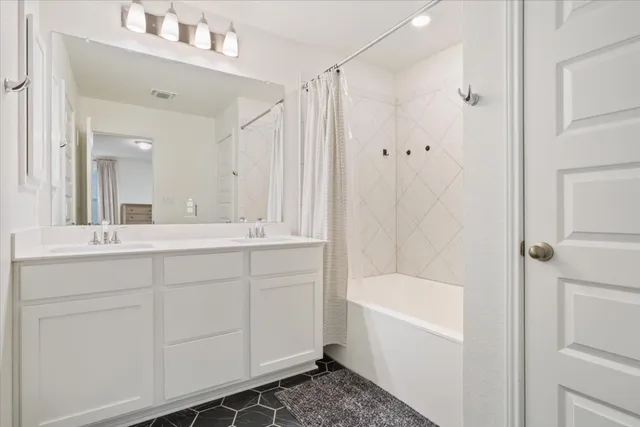 a bathroom with a tub sink and mirror