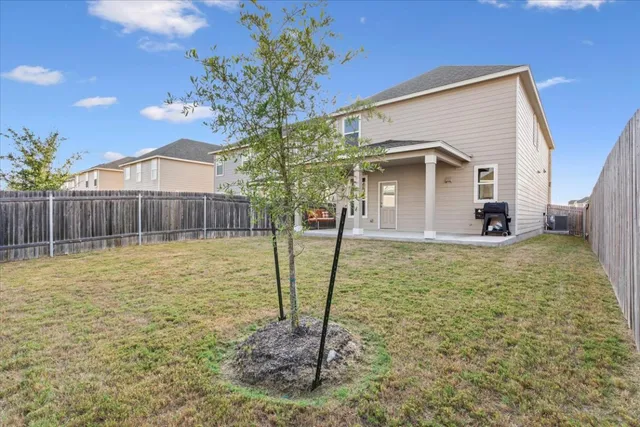 a view of a house with a wooden fence