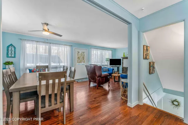 a living room with furniture dining table and a large window