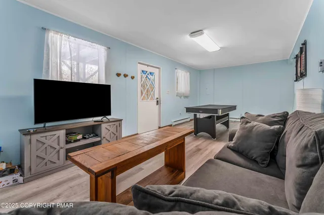 a living room with furniture and a flat screen tv