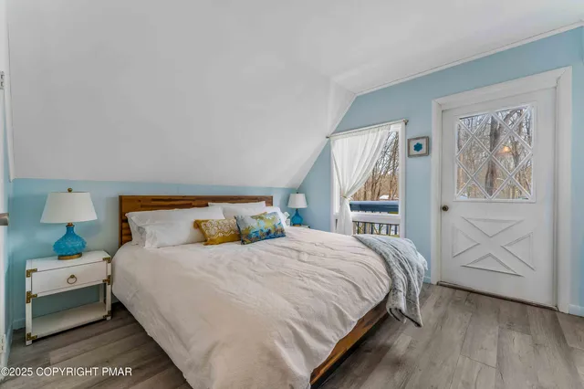 a bedroom with a large bed a lamp and a window