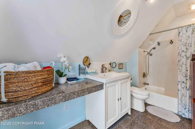 a bathroom with a granite countertop sink and a large mirror