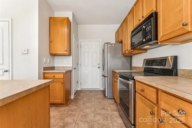 a bedroom with a bed a window and a potted plant