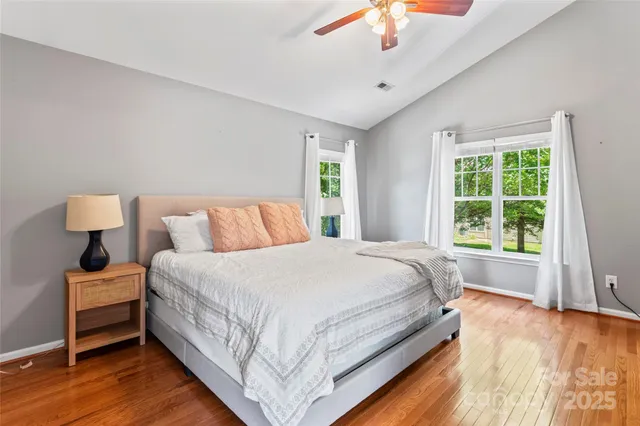 a bedroom with a bed and a large window