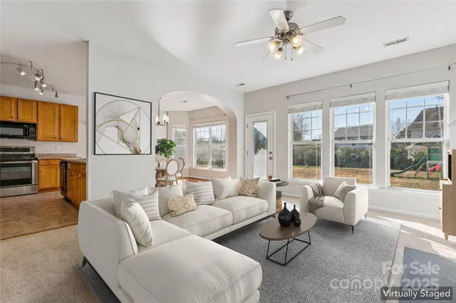a dining room with wooden floor a chandelier a wooden table and chairs