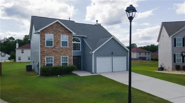 a front view of house with yard and green space