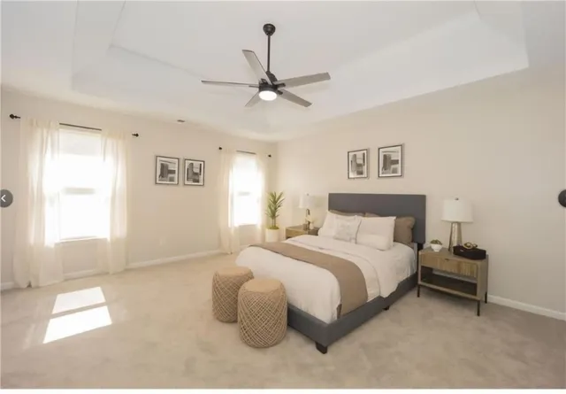 a spacious bedroom with a bed and a chandelier