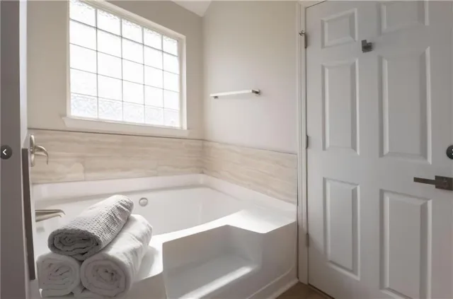 a bathroom with a bathtub and a shower