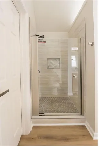 a bathroom with a glass shower door